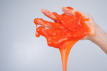 Red slime flowing down from a woman's hand on a white background. 