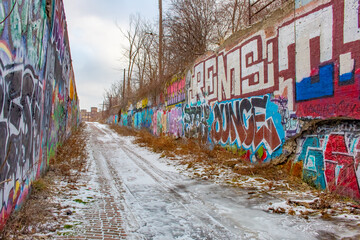 Colorful graffiti urban artwork in a wall in an alley in Detroit Michigan