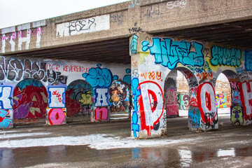 Colorful urban graffiti artwork on and under a bridge in downtown Detroit Michigan