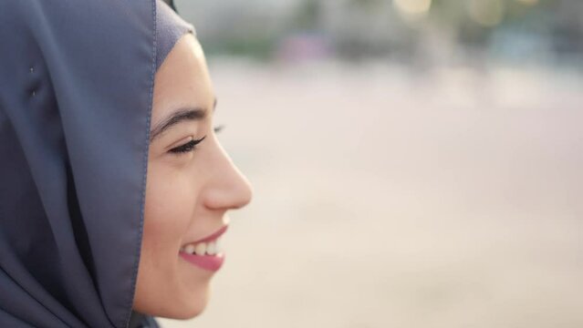 Image with copy space of a serious muslim woman starting to smile