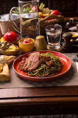 Green sauce pesto spaghetti with pork chop peruvian gourmet comfort food