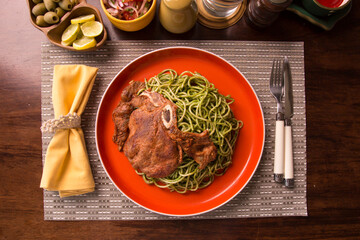 Green sauce pesto spaghetti with pork chop peruvian gourmet comfort food