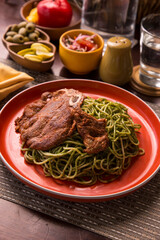 Green sauce pesto spaghetti with pork chop peruvian gourmet comfort food