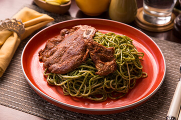 Green sauce pesto spaghetti with pork chop peruvian gourmet comfort food