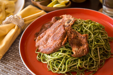 Green sauce pesto spaghetti with pork chop peruvian gourmet comfort food