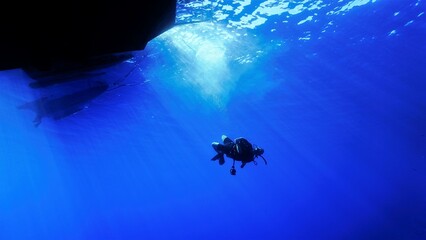 Underwater photo of a scuba diver in rays of light. Art and home decoration for your interior design.