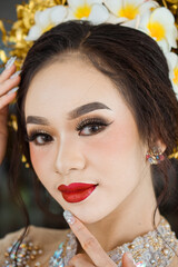 Beautiful Indonesian woman wearing KEBAYA. KEBAYA is a type of upper garment that is traditionally worn by women in Southeast Asia, especially in Indonesia.