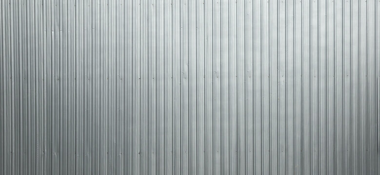 Galvanized metal sheet used to make fences in construction sites. A panoramic image of a metal sheet suitable for use as a background.