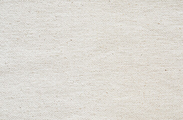 Fototapeta na wymiar Close-up of natural fabric texture. Light beige cloth background. Natural linen or cotton textile material.