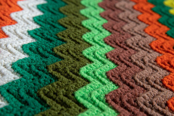 Fototapeta premium close-up of grandma's retro zigzag striped blanket, crocheted or knitted, grandma's house, cozy and warm
