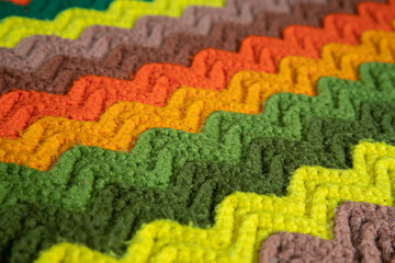 close-up of grandma's retro zigzag striped blanket, crocheted or knitted, grandma's house, cozy and...