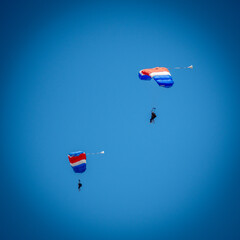 Isolated free skydivers gliding their parachutes for landing- Israel