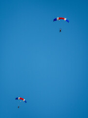 Isolated free skydivers gliding their parachutes for landing- Israel
