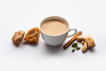 Jaggery tea or Gur ki chai with ingredients like gud, ginger or adrak, green cardamom and cinnamon - obrazy, fototapety, plakaty