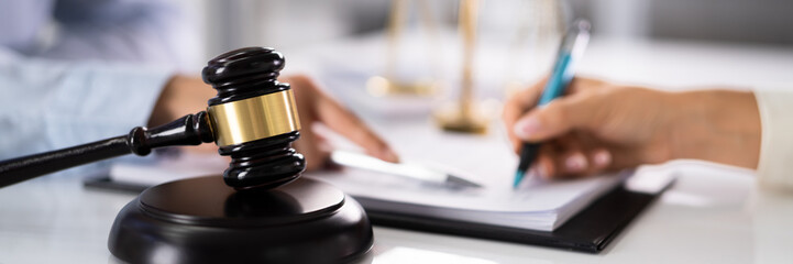 Judge Assisting Client To Sign Legal Document