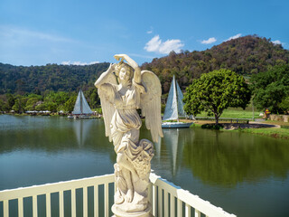 Beautiful angel in terrace of lake