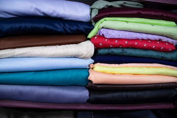 Patterned Textile Fabrics  stacked on a retail Shop Shelf for sale