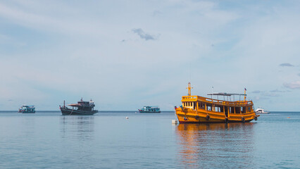 Fototapeta premium Three dive boats on the horizon of a dive site in Koh Tao, Thailand