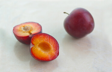 Fototapeta na wymiar halved red plums