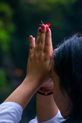 Balinese Girl Praying holding a flower