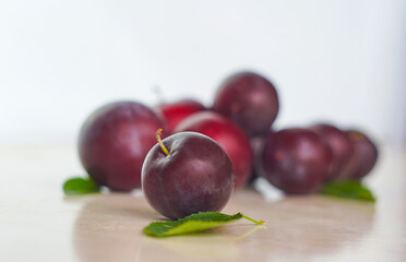 Plums in a red bowl