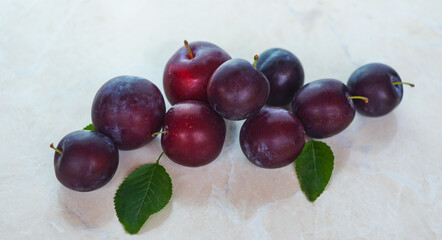 Plums in a red bowl