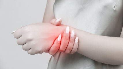 young woman experiencing pain in the joint of the hand