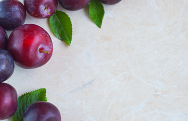 Plums in a red bowl