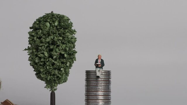 The concept of the gap between rich and poor. Business concept with piles of coins and miniature people.
