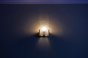 Wall lamp with yellow shade from canvas or wall.