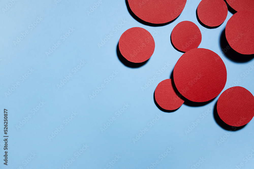 Poster red circles soar on blue background in hard light with shadows as abstract colorful geometric border
