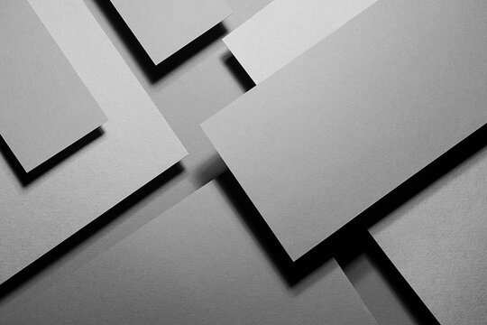 Grey carbon abstract geometric background with soar rectangle surfaces with corners, stripes in hard light, black shadows - monochrome style backdrop in elegant simple modern minimal style, top view.