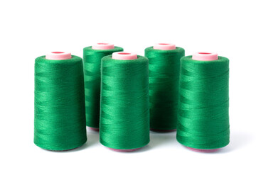 Spools of green sewing thread isolated on white background. The concept of clothing production. Side view