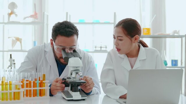 Scientist team use microscope in the lab. Biotechnology researcher scientist working look microscope in the medical development laboratory for vaccine development