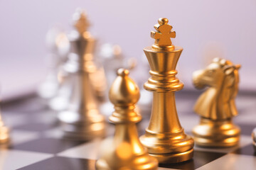 silver and gold chess are facing each other, business management ideas strategize to conquer opponents.