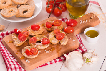 Friselle with cherry tomatoes and olive oil.