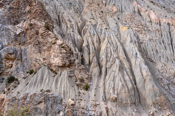Fototapeta na wymiar Landscape detail view of geological rock formations on mountainside in Iskander darya river valley near Iskanderkul lake, Fann mountains, Sughd region, Tajikistan
