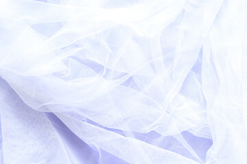 white tulle cloth on purple paper background