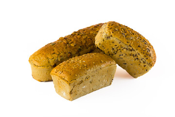 Healthier variations of traditional bread. Three whole grain loaves of bread placed together. Pumpkin seed, oats, flaxseed, and sunflower seeds as toppings. Isolated on white background. High quality