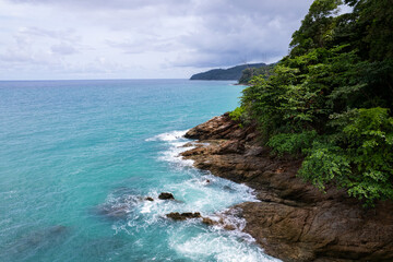 Aerial view of sea crashing waves White foaming waves on seashore rocks Top view Rocky coast mountain landscape view Nature background