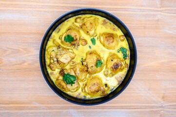 Fresh chicken tikka masala freshly cooked in a home kitchen close-up.
