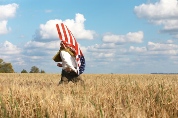 Man waving American flag standing in grass farm agricultural field , holidays, patriotism, pride, freedom, political parties, immigrant