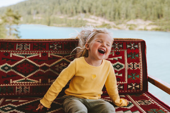 Child girl happy laughing emotional kid cute blonde hair baby outdoor 3 years old kid having fun family lifestyle travel vacations