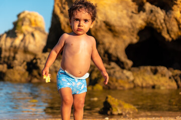 A boy on summer vacation at Praia dos Arrifes, Algarve beach, Albufeira. Portugal