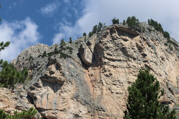 Val Badia, Italy-July 18, 2022: The italian Dolomites behind the small village of Corvara in summer days with beaitiful blue sky in the background. Green nature in the middle of the rocks.