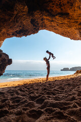 Having fun with the son in the beach cave in the Algarve, Praia da Coelha, Albufeira. Portugal