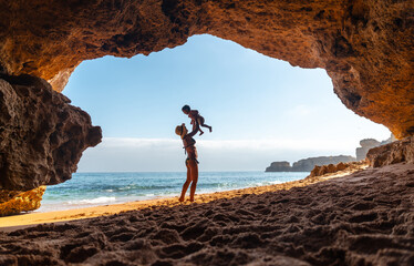 Having fun with the son in the beach cave in the Algarve, Praia da Coelha, Albufeira. Portugal
