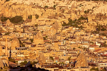 view of the city of Geremes with a mosque and a minoret in Cappadocia from a hot air balloon in the early morning. Journey on a balloon in the highlands.