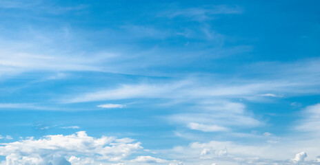 Sky with fluffy white cloudscape texture. Wide blue sky nature background, horizontal