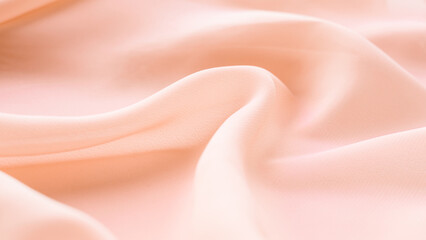 folds of beige silk fabric texture background